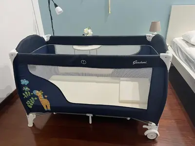 a blue and white crib in a bedroom at Casa a San Giovanni - Charming Flat in Rome in Rome
