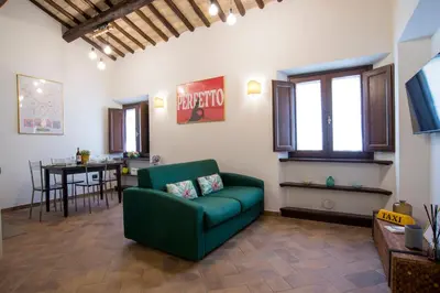 a living room with a green couch and a table at Cacio e Pepe FLATS 1 & 2 in Rome