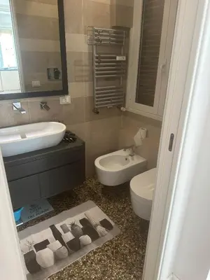 a bathroom with a sink and a toilet and a mirror at 4venti house in Rome
