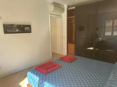 a bedroom with a bed with two red towels on it at 4venti house in Rome