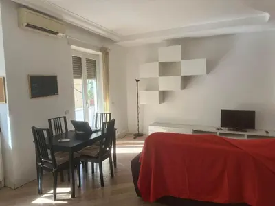 a bedroom with a table and chairs and a laptop at 4venti house in Rome