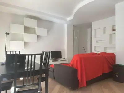 a dining room with a table and a red blanket at 4venti house in Rome