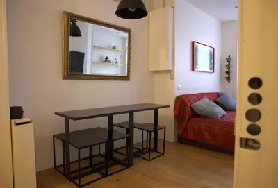 a room with a table and a couch and a mirror at La Casetta in Rome