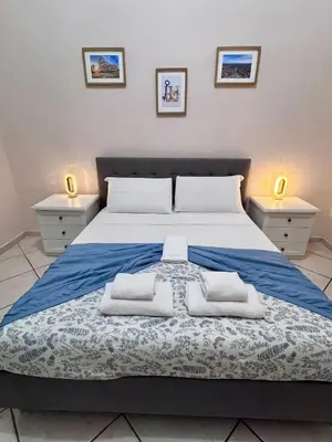 a bedroom with a large bed with towels on it at Rome Is Home in Rome