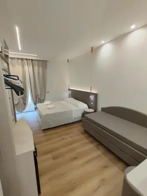 a bedroom with two beds in a room with wooden floors at Charlie Up! in Rome