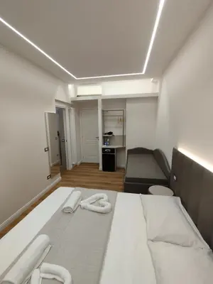 a bedroom with a bed with two slippers on it at Charlie Up! in Rome