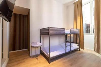 a room with two bunk beds in it at Cunabu Urbano V in Rome