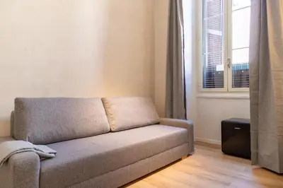 a couch in a living room with a window at Cunabu Urbano V in Rome