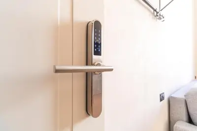 a metal door handle on a white door at Cunabu Urbano V in Rome