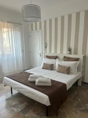 a bedroom with a large bed with two towels on it at Appartamento San Pietro Alla Cupola in Rome