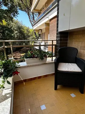 a chair sitting on a balcony with plants at Appartamento San Pietro Alla Cupola in Rome
