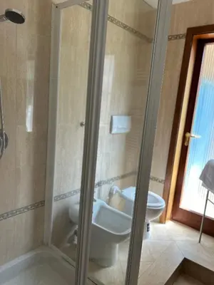a bathroom with a shower and a toilet and a sink at Appartamento San Pietro Alla Cupola in Rome