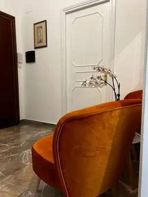 a chair sitting in a room with a door at Appartamento San Pietro Alla Cupola in Rome