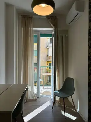 a room with a desk and a chair and a window at Green House Rome in Rome