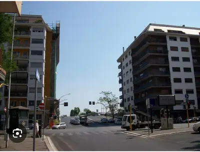 a city street with a traffic light and buildings at Green House Rome in Rome