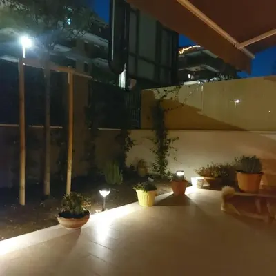 a group of potted plants on a patio at night at Monolocale nuova costruzione con giardino in Rome