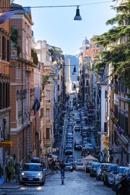 a busy city street with cars parked on the street at Panoramic Quirinal Penthouse in Rome