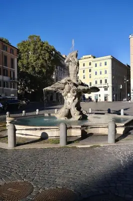 a statue of a fountain in a city at Panoramic Quirinal Penthouse in Rome