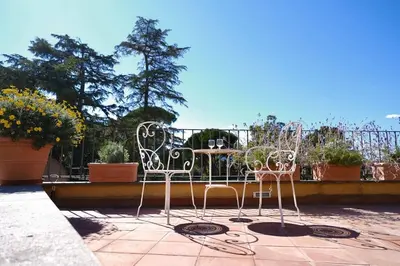 two chairs and a table on a patio at Panoramic Quirinal Penthouse in Rome