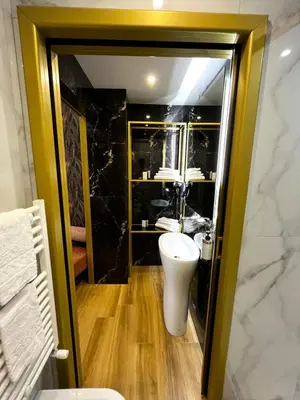 a bathroom with a white toilet and a sink at Mavi Luxury Suites in Rome