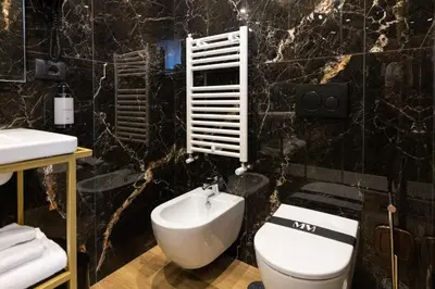 a bathroom with a toilet and a sink at Mavi Luxury Suites in Rome