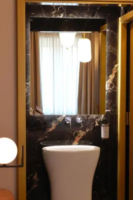 a bathroom with a sink and a mirror at Mavi Luxury Suites in Rome