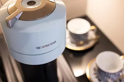 a bottle of wine and two cups on a table at Mavi Luxury Suites in Rome