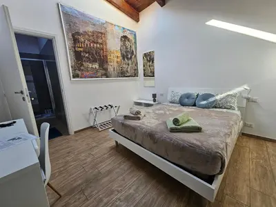 a bedroom with a large bed with blue pillows at LUXURY Amazing Appia Antica - CELIO in Rome