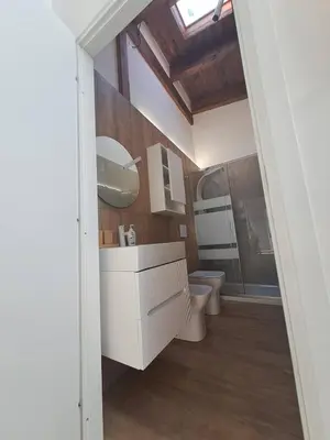 a bathroom with a toilet and a sink and a mirror at LUXURY Amazing Appia Antica - CELIO in Rome