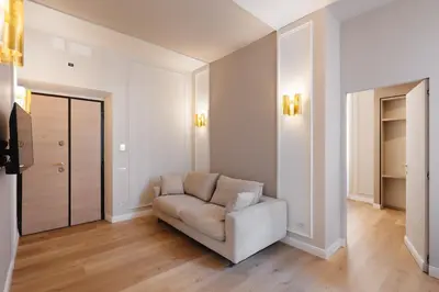 a white living room with a couch and a mirror at Firenze Boutique Rooms in Rome