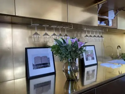 a vase of flowers on a counter with pictures at Roma magica in Rome