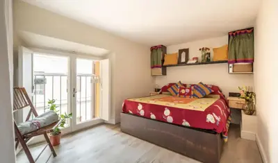 a bedroom with a bed with red sheets and a window at Roma magica in Rome