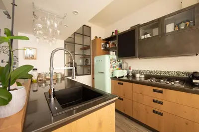 a kitchen with a sink and a refrigerator at La casa di Ele in Rome
