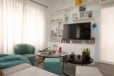 a living room with a table and a tv at La casa di Ele in Rome