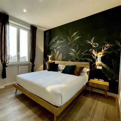 a bedroom with a large bed with a painting on the wall at Elements in Rome