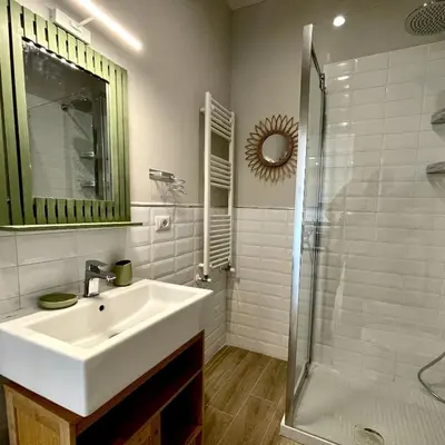 a white bathroom with a sink and a shower at Elements in Rome