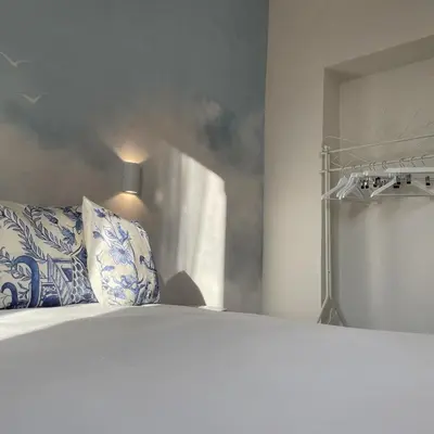 a bedroom with a large bed with blue and white pillows at Elements in Rome