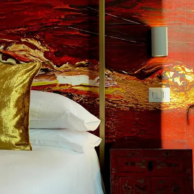 a bedroom with a bed with a painting on the wall at Elements in Rome