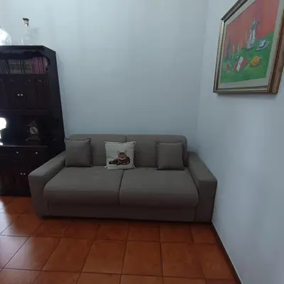 a gray couch with a pillow on it in a living room at Attico Aventino in Rome