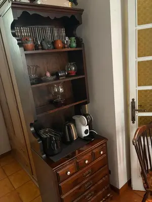 a room with a wooden cabinet and a wooden dresser at Attico Aventino in Rome