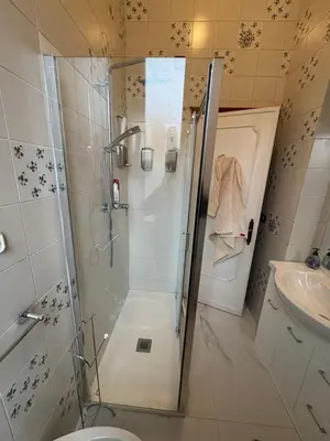 a bathroom with a shower and a sink at Attico Aventino in Rome