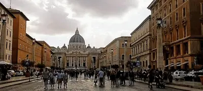 a group of people walking down a city street at Attico Aventino in Rome