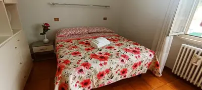a bedroom with a bed with a red and white blanket at Attico Aventino in Rome