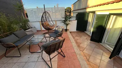 a patio with chairs and a swing on a balcony at Testaccio Terrace,Perfect for families or small groups in Rome