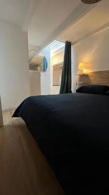 a bedroom with a black bed and a window at Testaccio Terrace,Perfect for families or small groups in Rome