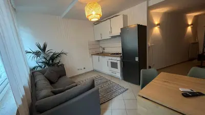 a living room with a couch and a kitchen at Testaccio Terrace,Perfect for families or small groups in Rome
