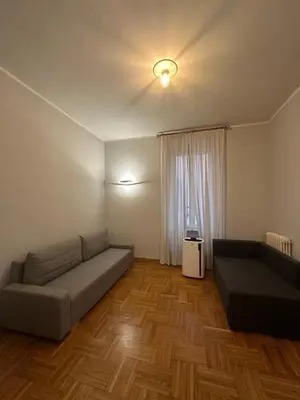a living room with a couch and a window at Cerri apartment in Rome