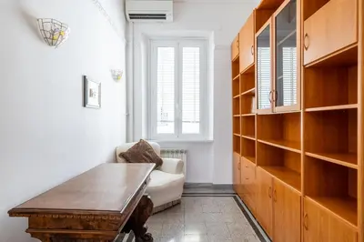 a living room with a wooden table and a couch at Piazza Caprera - Family Apartment in Rome