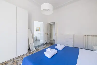 a room with two towels on a blue blanket at Piazza Caprera - Family Apartment in Rome
