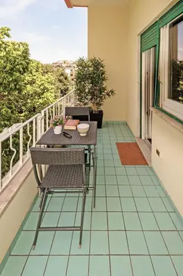 a patio with a table and chairs on a balcony at E&L apt 150sqm 3BR Metro 30m Park in Rome